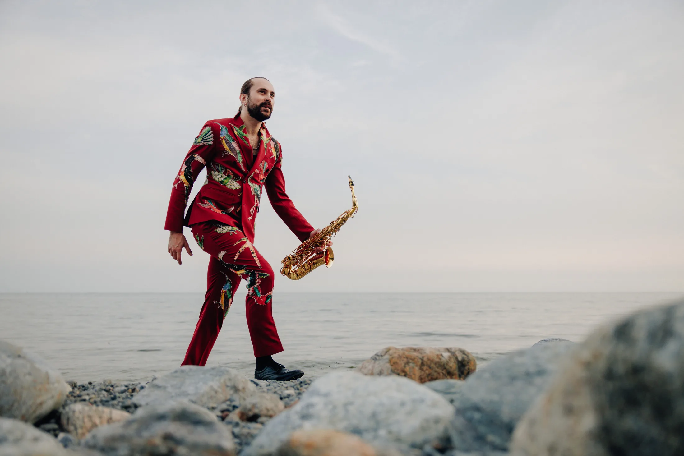 Andreas Ferronato takes an energetic saxophone stride by the sea