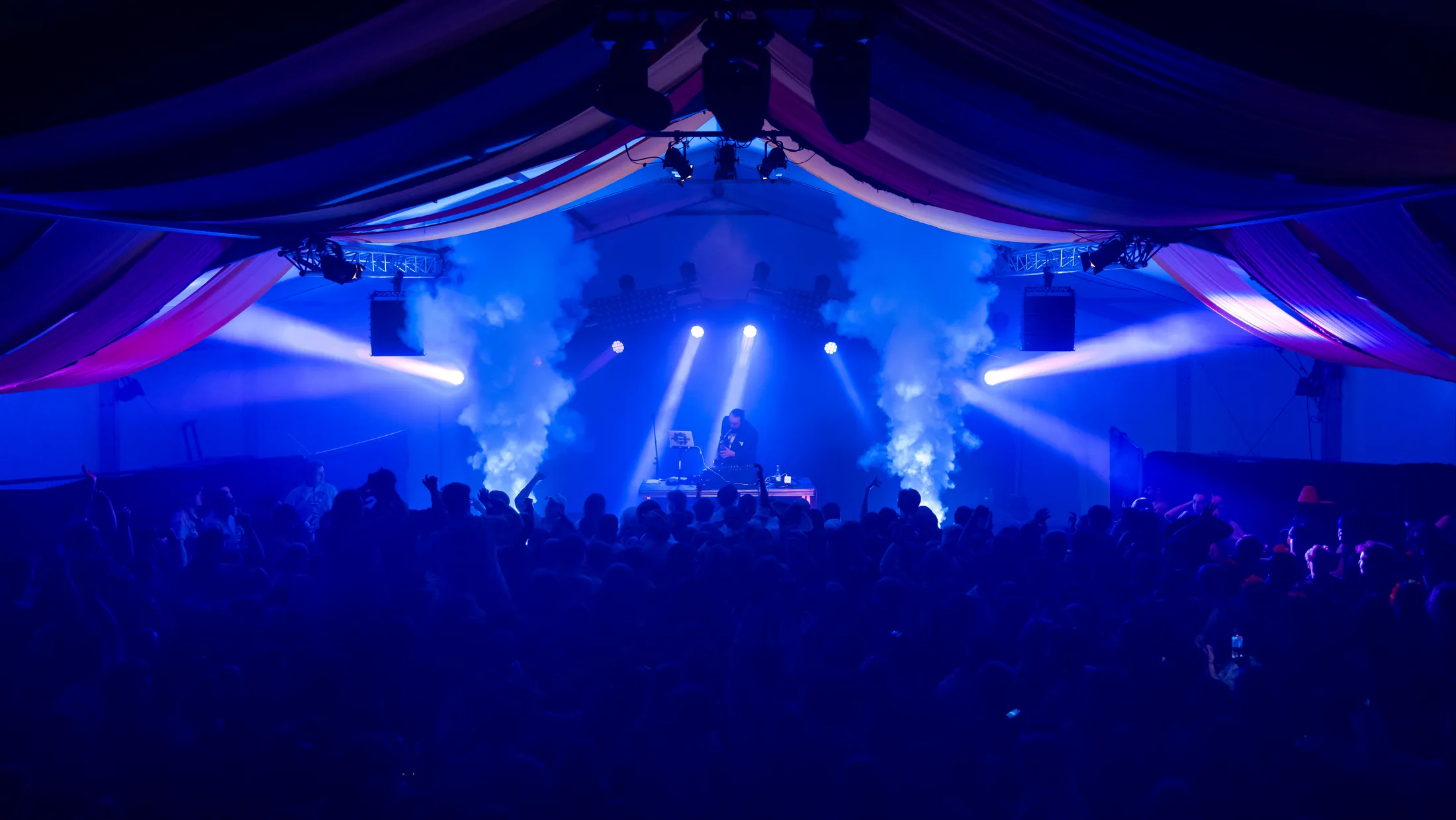 Concert audience in blue stage lighting